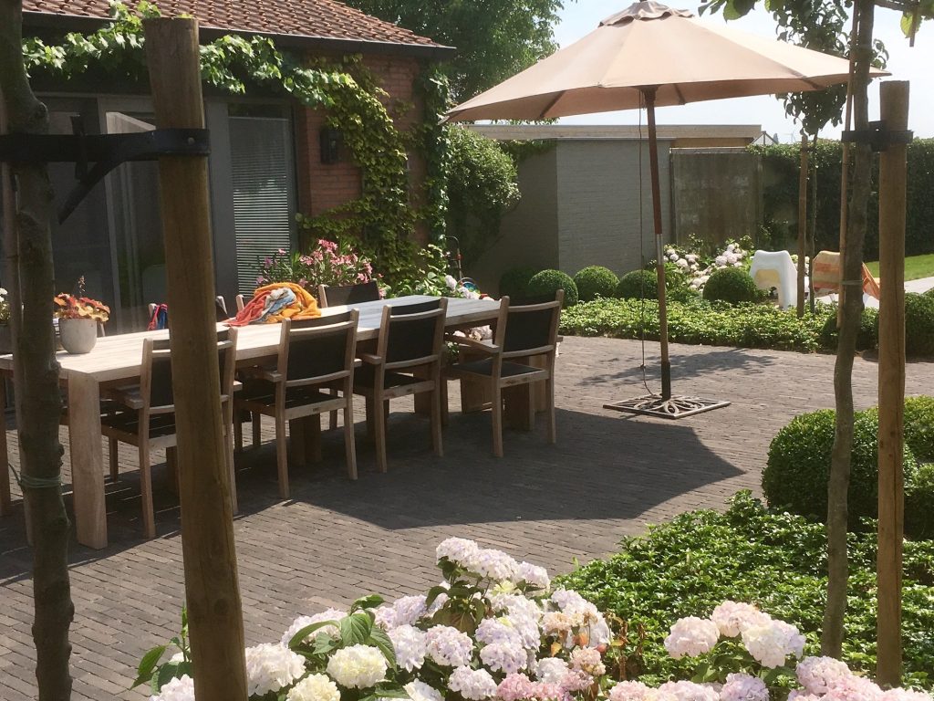 Gezellige vrije tuin met bloeiende perkjes